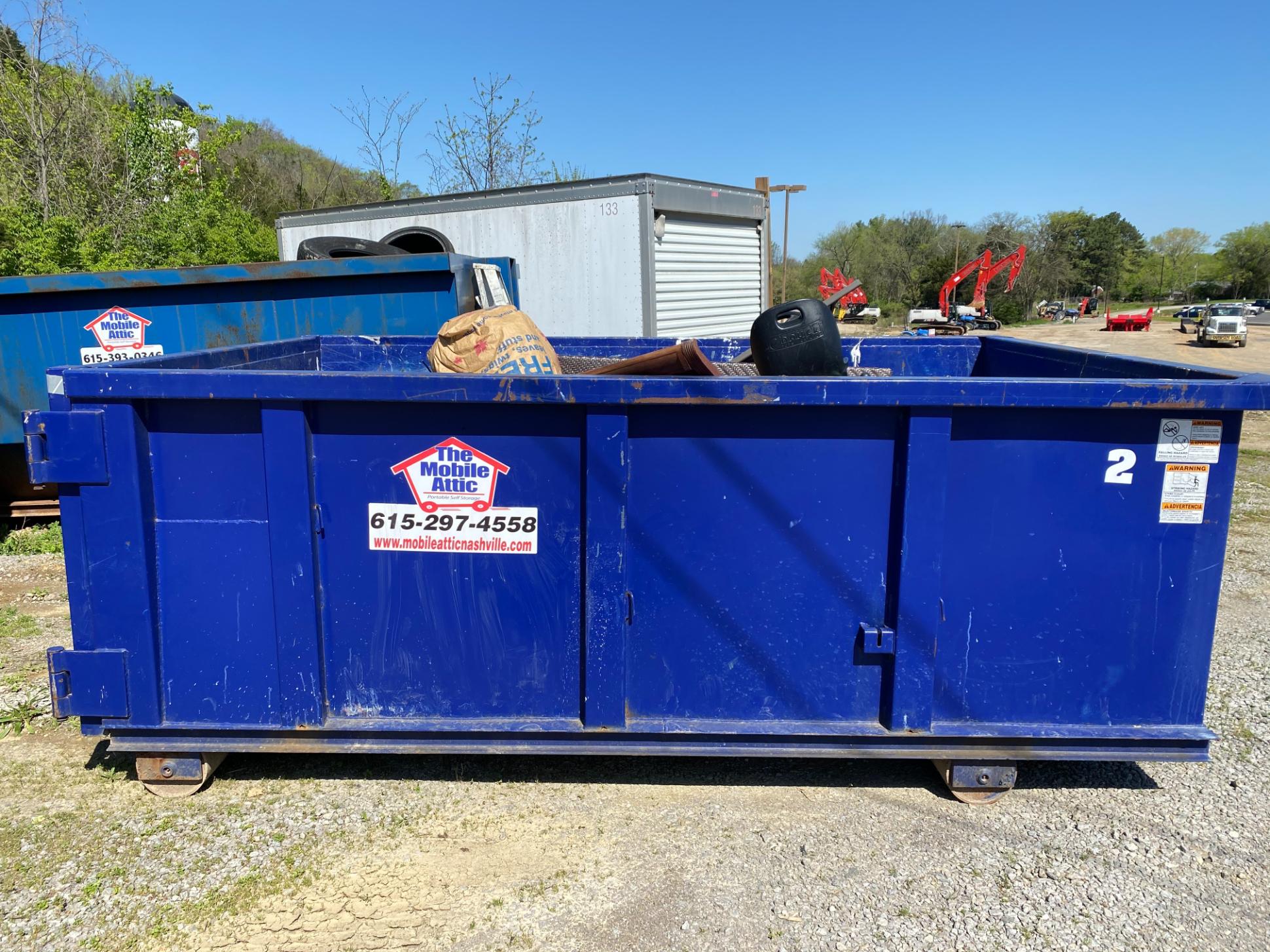 Mobile Attic providing licensed dumpster rental service on job site