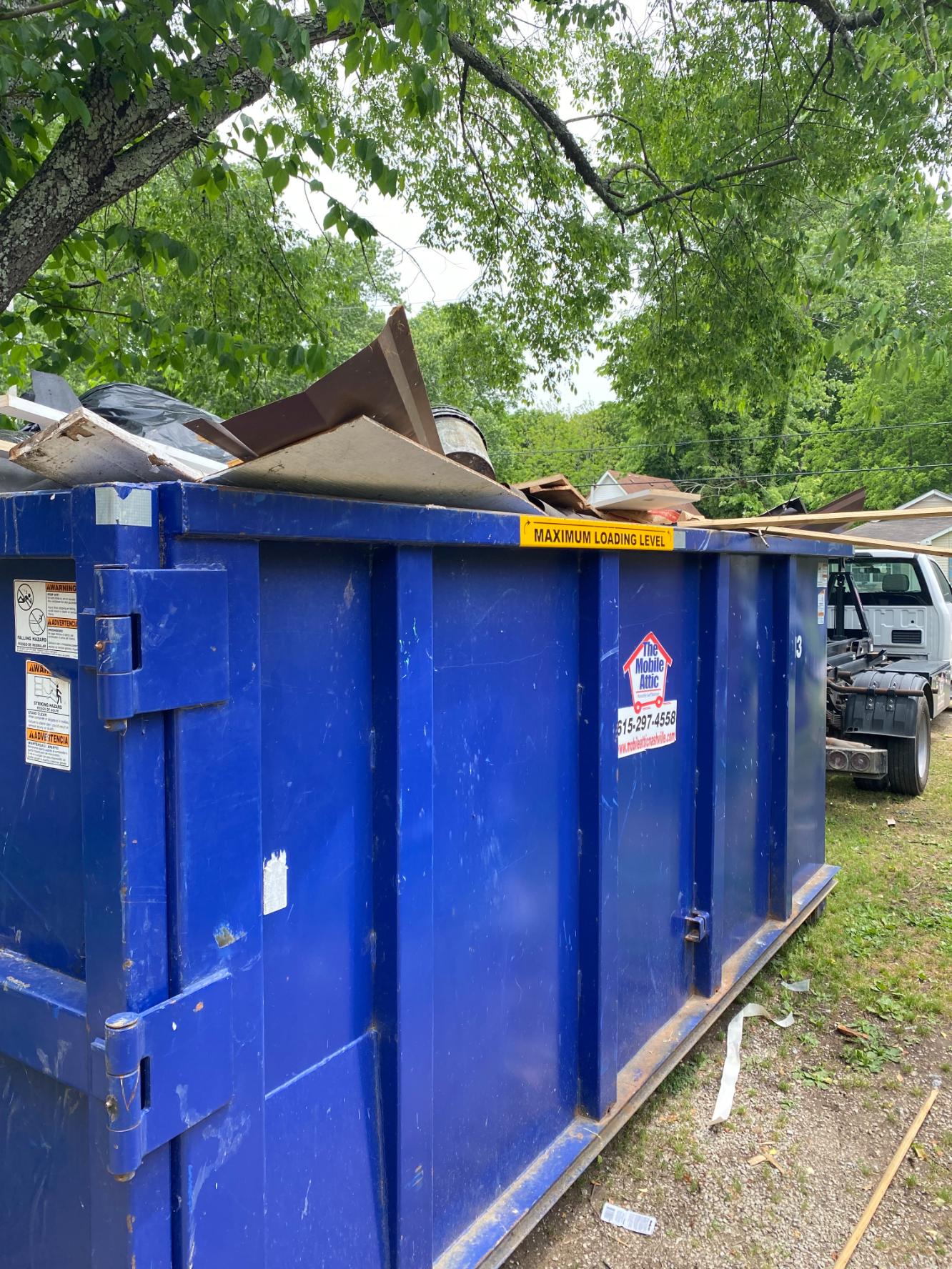 Mobile Attic dumpster rental assisting with property cleanout