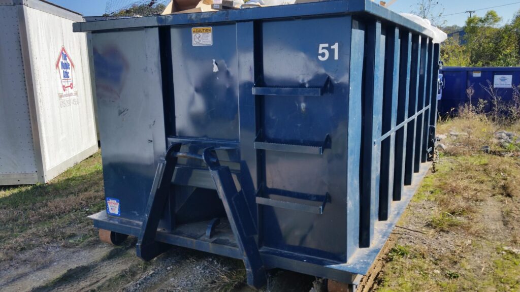 licensed dumpster rental container positioned for remodeling project