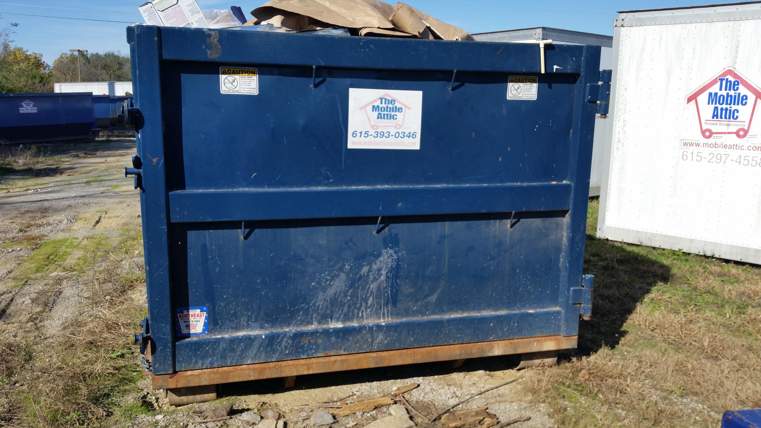 Mobile Attic dumpster rental placed for efficient debris disposal