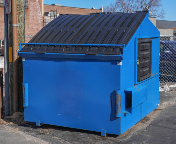 Team member inspecting loaded dumpster for safety and compliance at a Goodlettsville residential site