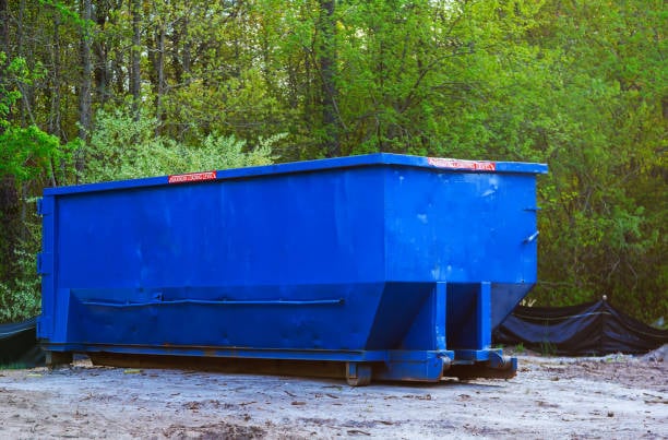 Commercial property manager overseeing cleanup crew loading debris into large dumpster at Cool Springs business complex