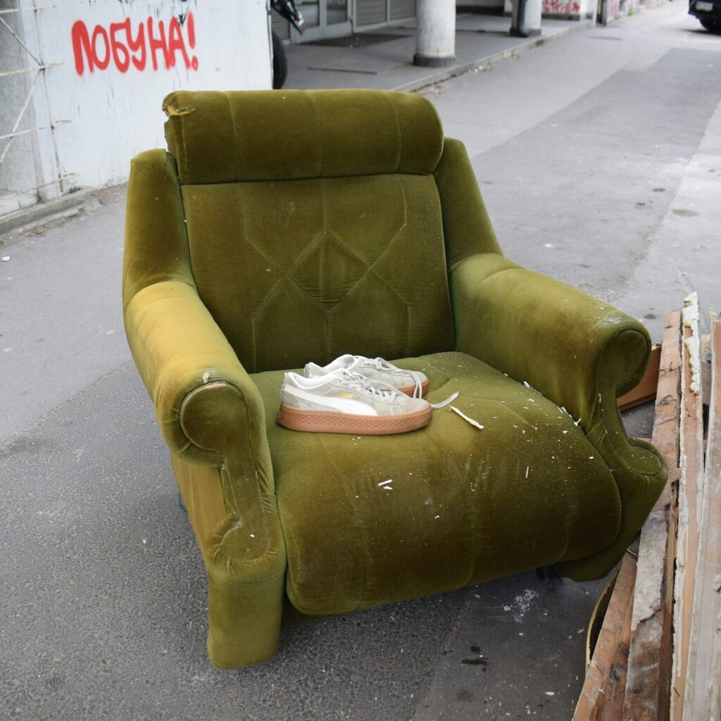 Discarded furniture prepared for commercial property cleanup, representing Commercial Dumpster Rental services near me.